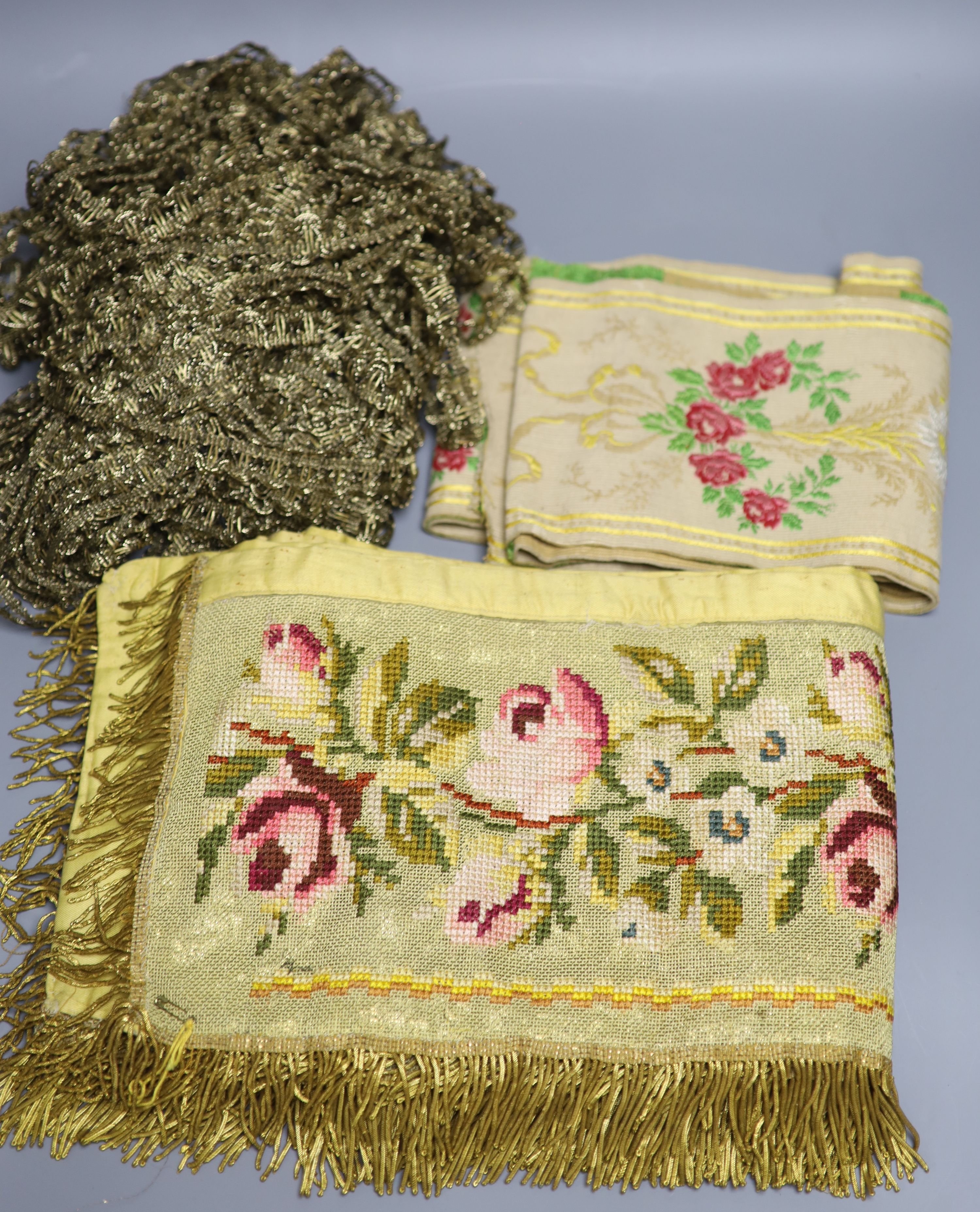 A Lurex 19th century cross stitch pelmet with gold coloured metal bullion fringing, a long French floral braid and a quantity of gold c